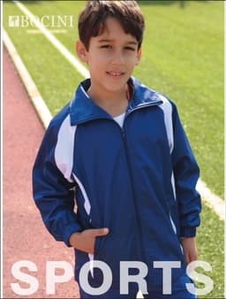 A blue and white kids' track jacket with a logo, worn by a boy standing on an athletic track.