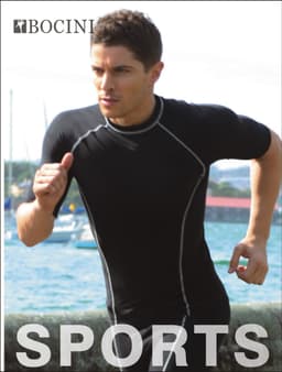 A man in a black performance wear shirt runs near the water. The shirt features a logo and sporty design details.