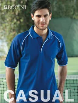 A blue unisex raglan polo shirt with white detailing and a logo, displayed on a model in a casual setting.