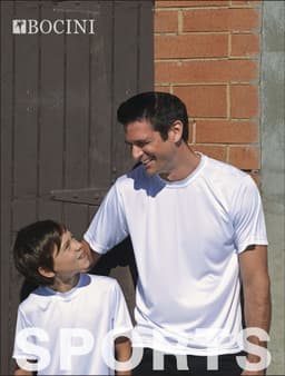 A white sublimation T-shirt, designed for kids, worn by a boy and a man, both smiling against a brick wall.
