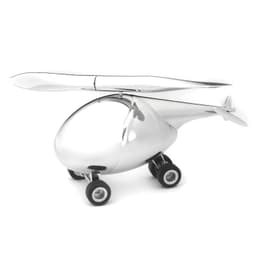 A shiny silver helicopter-shaped letter opener with small black wheels and a propeller.