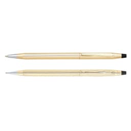 A brass pen set in 10CT gold, featuring a ballpoint pen and mechanical pencil, both with a shiny finish and branding.