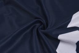 A navy baseball vest featuring a textured fabric with a white logo design. It has a branded logo present.