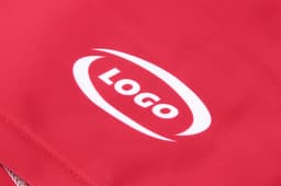 A red running suit featuring a prominent logo. Ideal for various sports activities.