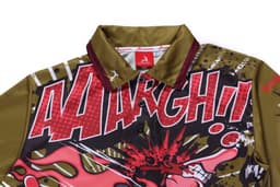 A customised motorcycle shirt featuring bold graphics in red, green, and black, with a collar and logo.