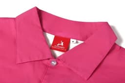 A pink women's beach shirt featuring a collar and a button. It has a label showing brand information.