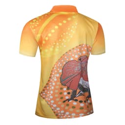A polo shirt featuring a vibrant orange design with circular patterns and a frog illustration. It has a logo.
