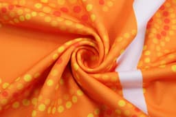 A vibrant orange fabric with yellow and red circular patterns, featuring a smooth, swirling texture.