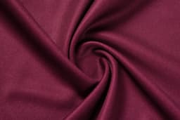 A deep burgundy fabric in a swirling pattern, showcasing a smooth texture. The image features a logo.