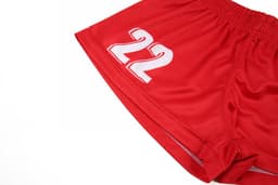 Red women's volleyball uniform shorts featuring a white number 22 and an elastic waistband.