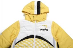 Yellow winter coat with removable sleeves and hood, featuring a logo and patterned design.
