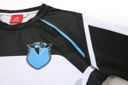 A sports uniform in black and white with blue accents and a logo on the front.