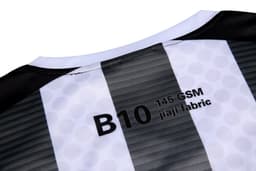 A black and white jersey featuring a striped design and a label indicating fabric type and GSM.
