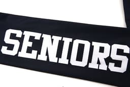 A black leavers jacket featuring white lettering that reads "SENIORS". The item has a logo.