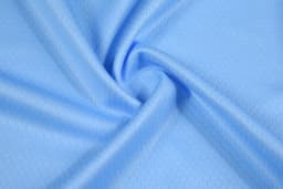 A light blue fabric with a subtle honeycomb pattern, showcasing a smooth, soft texture.