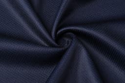 A navy blue fabric with a textured, breathable pattern, arranged in a spiraled fold.