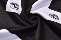 A black and white PLAYER SINGLET featuring two logos, showcasing a textured fabric design.