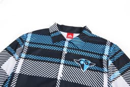 A flannel shirt in a black, blue, and white geometric pattern, featuring a logo on the chest.