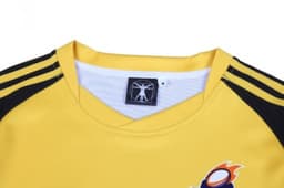 A yellow hoodie with black sleeves and a logo at the neckline.