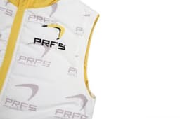 A white and yellow puffer vest with removable sleeves and hood, featuring a logo on the front.