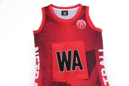 A red netball dress featuring a white design and a central pocket, with a logo on the neckline.
