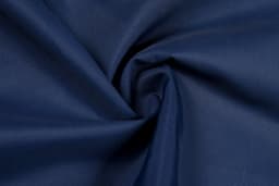 A close-up of navy blue cotton fabric with a smooth texture, showcasing its soft lining.