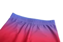 Tight shorts featuring a gradient design from purple to red, with an elastic waistband. The shorts have a smooth finish and branding.
