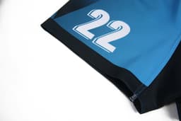 A pair of rugby uniform shorts in blue and black, featuring a large white '22' and a logo.