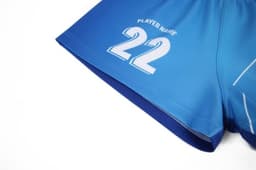 A blue sports jersey featuring a white number 22 and a logo. The fabric appears lightweight and flexible.