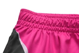 A close-up of the waistband of pink sports pants featuring a black side panel and elasticised band.