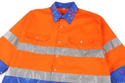 A vibrant orange Hawaiian shirt with reflective silver stripes and a blue patterned collar, featuring a logo.