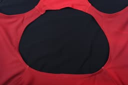 A red women's swimming one-piece with a circular cutout at the back, featuring a logo.