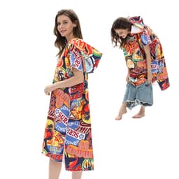 A colourful poncho towel featuring a vibrant mix of graphics and a hood. It has an eye-catching design with various patterns.