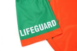 A bright orange and green quarter zip uniform with "LIFEGUARD" text, featuring a simple design and logo.