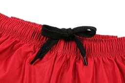 Red women’s soccer uniform shorts featuring a black drawstring at the waistband and a logo.