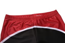 Red and black athletic shorts with a white detail, featuring an elastic waistband and a smooth fabric texture.
