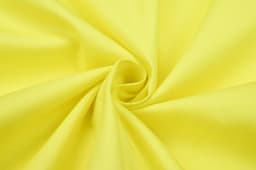 A close-up of bright yellow fabric, showcasing the texture and smoothness of the textile.