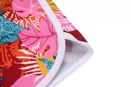 A vibrant beach shirt featuring a tropical floral pattern in pink, red, and green, with white trim.