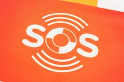 A bright orange fabric featuring a white logo consisting of the letters "SOS" and circular wave designs.