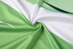 A multi-sport T-shirt in green and white, featuring a smooth, textured fabric with a swirling pattern.