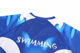 A blue swimwear top featuring a wave design and a branding logo on the back, with the word "SWIMMING".