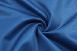 A blue fabric swatch with a smooth texture, arranged in a spiral pattern. The material appears lightweight and flexible.