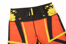 A pair of custom-made leggings featuring a bold design with orange, black, and yellow patterns.