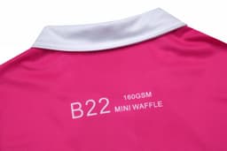 A pink women's polo shirt featuring a white collar and brand logo on the back.
