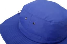 A wide brim hat in bright blue, featuring ventilation eyelets and a textured brim. The hat has a logo.