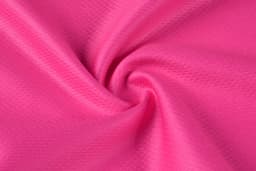 A close-up of pink fabric with a smooth, textured surface, showcasing a swirling pattern.