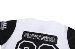A sports uniform featuring a predominantly white design with black sleeves and a logo, including a placeholder for a player name.