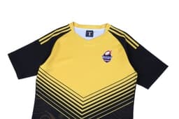 A yellow and black rugby jersey featuring a logo and a geometric design pattern on the front.
