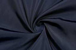 A dark navy fabric with a smooth texture, arranged in a spiral pattern, showcasing its soft feel.