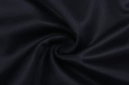A close-up of black fabric with a smooth texture, showing a swirl pattern. It features a subtle sheen.